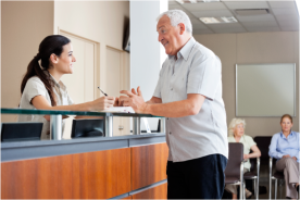 receptionist checking in patient 